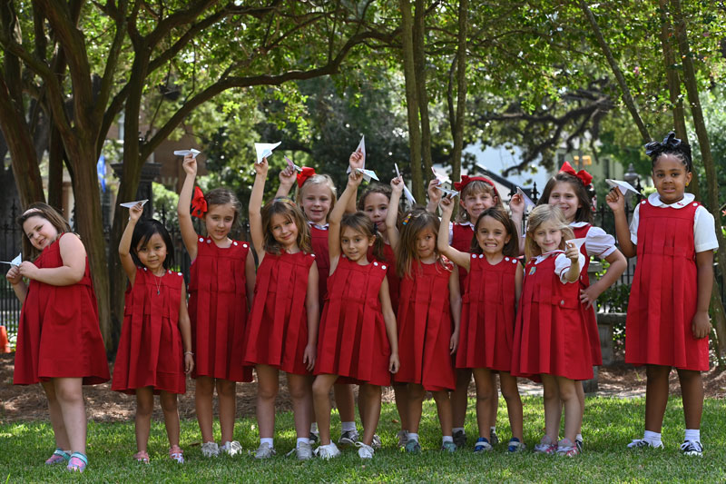 A group of girls in red dresses